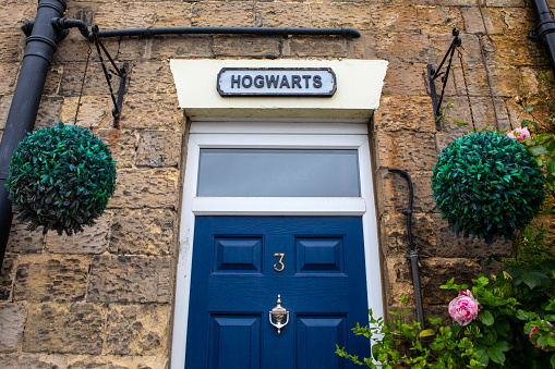 Pickering, UK - June 9th 2022: Hogwarts sign above a Cottage doorway in the town of Pickering in North Yorkshire, UK.