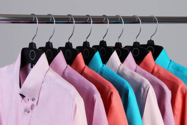 istock shirts of different colors hung on black hooks 1407161961