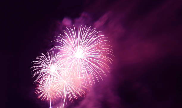 istock Fantastic magenta purple fireworks exploding into the city night sky 1407162225