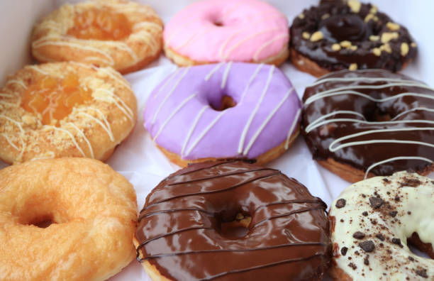 istock Closeup of delectable assorted doughnuts in a box 1407162755