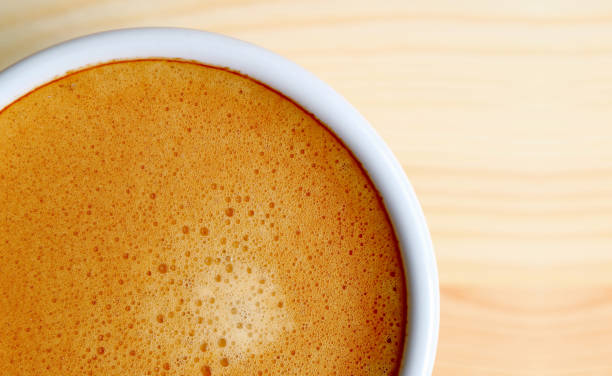 Top view of artistic texture of frothy hot coffee surface