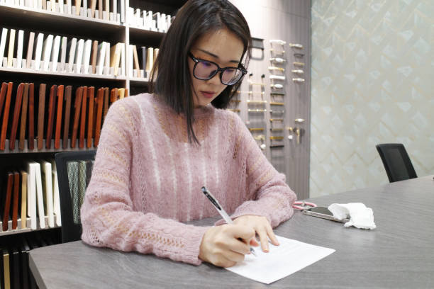 istock Beautiful lady writing at conference table 1407162928