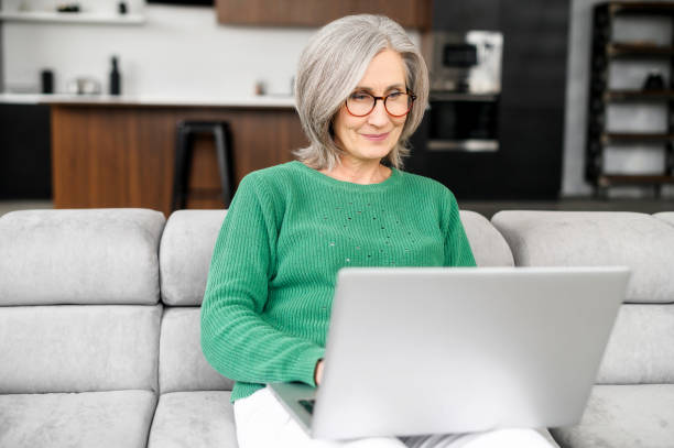 istock Relaxed senior female freelancer working on laptop 1407162999