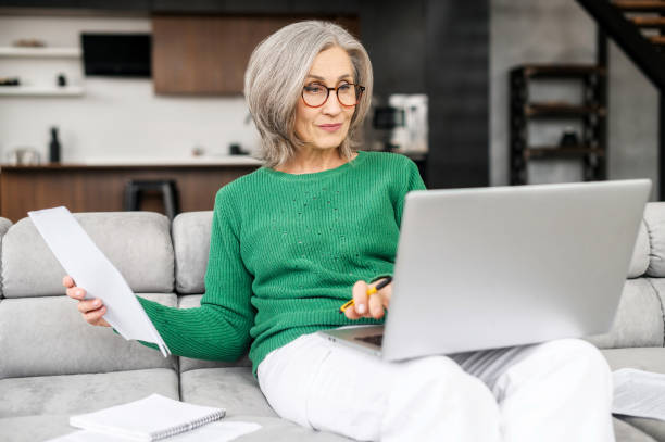 istock Beautiful senior woman using laptop at home 1407163013