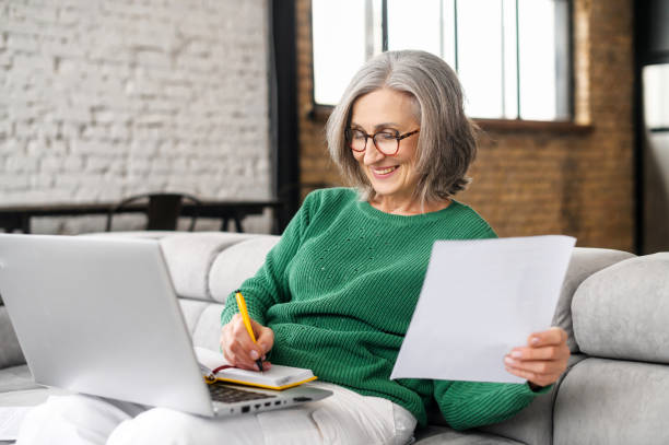 istock Happy mature accountant working remotely online 1407163015