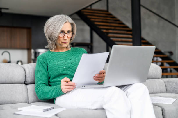 istock Busy focused mature lawyer checking papers 1407163018