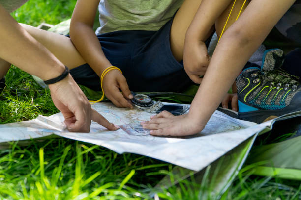 istock latin kids and woman or mother checking map with compass 1407164099