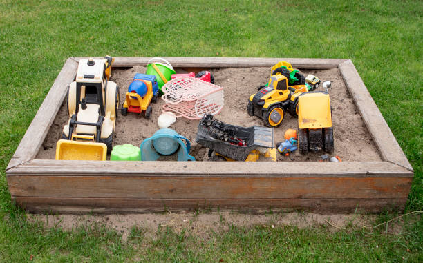 istock Children’s sandbox with toys on green grass 1407164207