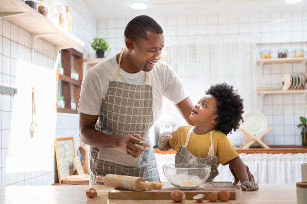 istock African American Father and son playing in kitchen 1407164499