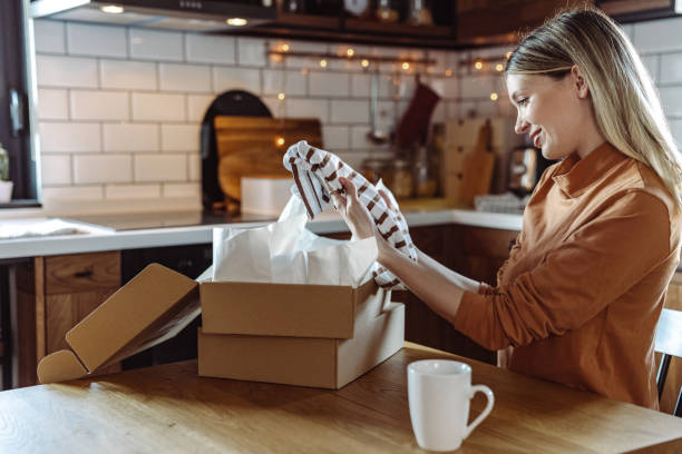 istock Satisfied young woman opening her online order 1407165348