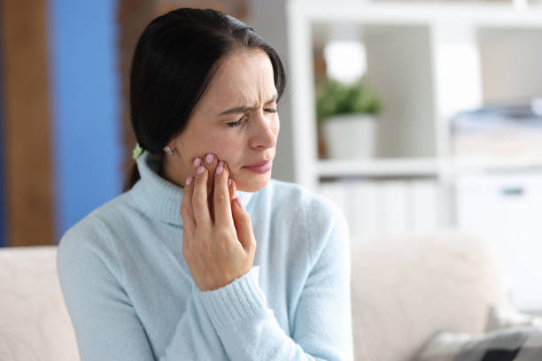 Young woman with severe toothache at home Young woman with severe toothache at home. Sudden pain in tooth concept jaw pain stock pictures, royalty-free photos & images
