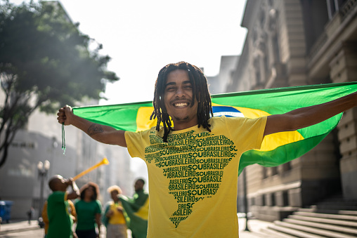 Portrait of a brazilian fan celebrating a soccer match on the city