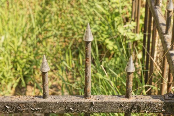 istock part of a gray black small metal decorative fence with three sharp iron bars 1407167728