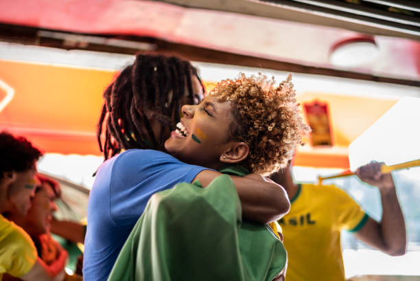 Brazilian fans embraced celebrating a soccer game Brazilian fans embraced celebrating a soccer game international soccer event photos stock pictures, royalty-free photos & images