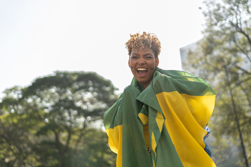 Portrait of a young woman with a brazilian flag