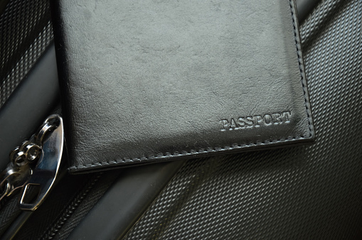a passport in a black cover on a travel suitcase. an identity document. background for the design