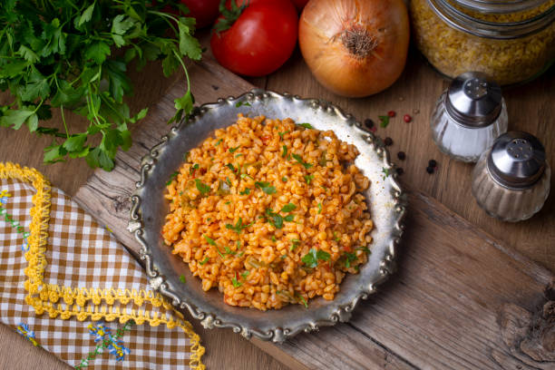 istock Traditional turkish bulgur pilaf with tomato sause in plate (Turkish name; meyhane pilavi) 1407170192