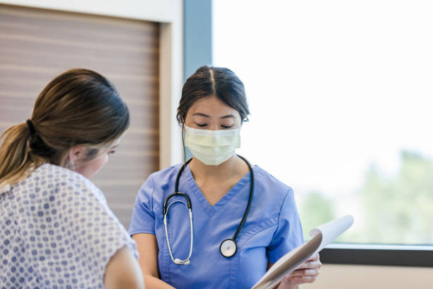 istock Doctor shows the patient her medical chart 1407170550