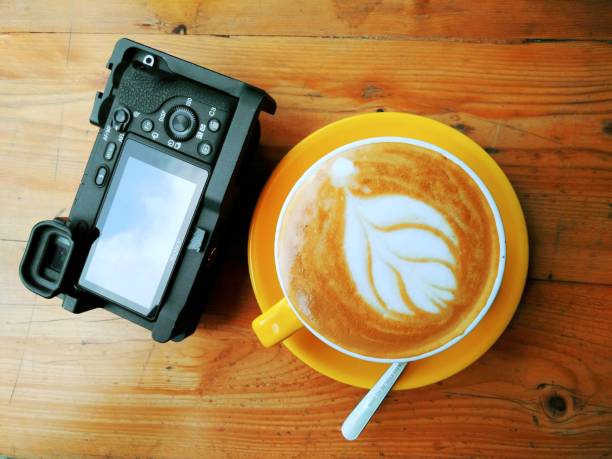 istock Camera and Coffee latte art on the table 1407171795