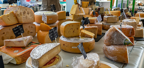 Limerick, Ireland - June 4, 2022: Variety of cheeses at the Milk Market, a traditional farmers market in Limerick, Ireland