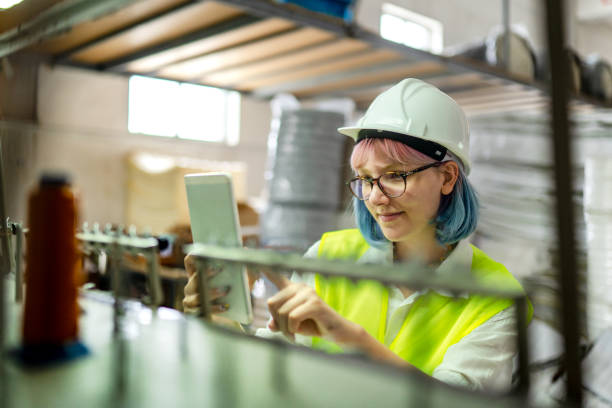 istock Young female engineer doing quality control  in a factory 1407173070