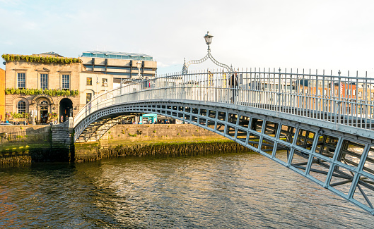 Dublin, Ireland - June 4, 2022: Ha'penny Bridge and officially the Liffey Bridge, a pedestrian bridge built in May 1816 over the River Liffey