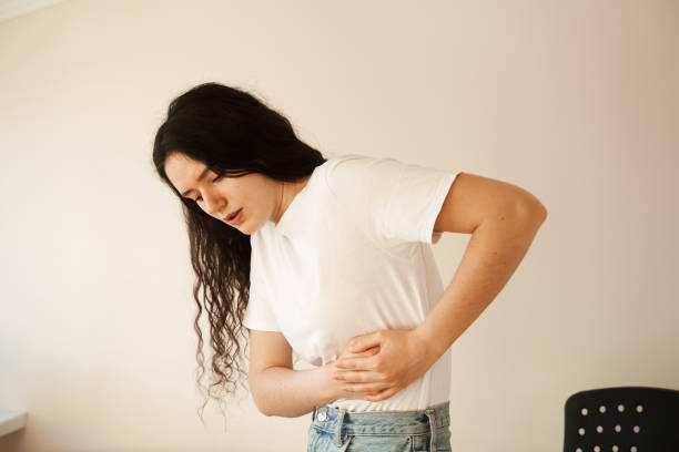 Stomach pain. Pancreatitis disease of pancreas becomes inflamed. Sick girl hold abdomen because it hurts. Stomach pain. Pancreatitis disease of pancreas becomes inflamed. Sick girl hold abdomen because it hurts endometriosis bloated stock pictures, royalty-free photos & images