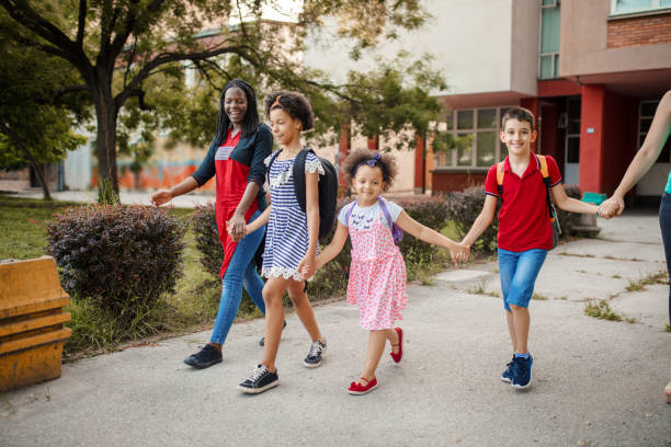 istock Two mothers taking their kids together to school 1407182510