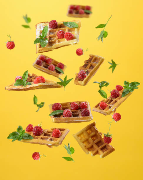istock Baked Belgian waffles, raspberries and mint leaves levitate 1407182710