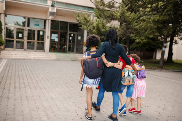 istock Black woman taking three kids to school 1407182721
