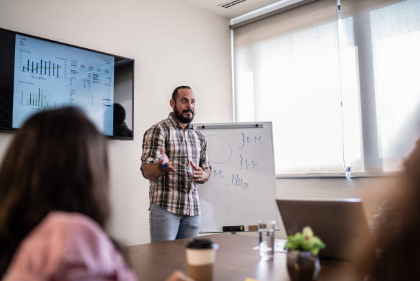 istock Mid adult man giving a presentation 1407182774