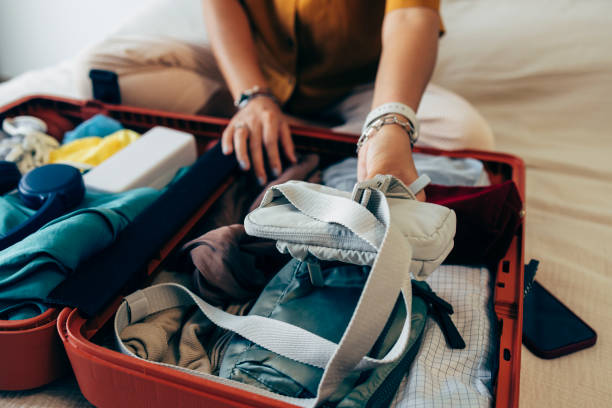 istock Anonymous Woman Packing Her Suitcase 1407182892