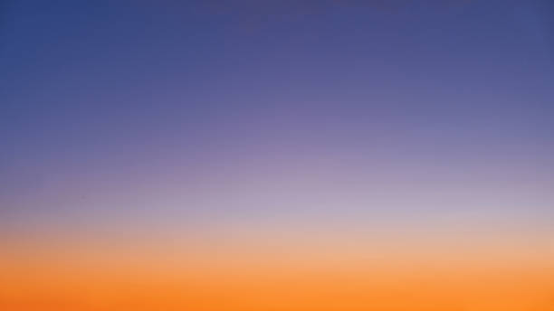 istock Gradient of orange-blue evening sky without clouds at sunset 1407183766