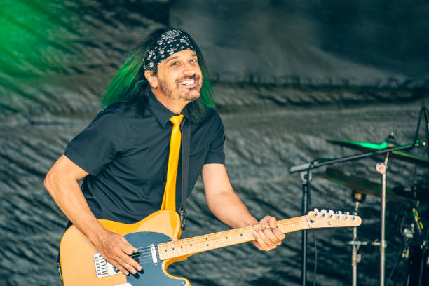 istock Smiling Guitarist Performing Live 1407184268