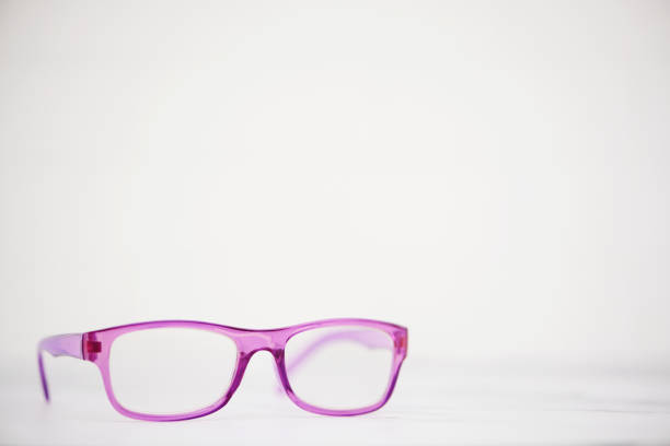Model of modern optical glasses frame supported on wood figures