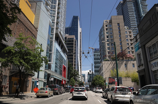 Vancouver, Canada - July 1, 2022: One-way traffic heads north on Seymour Street past downtown office and residential buildings on a summer afternoon.