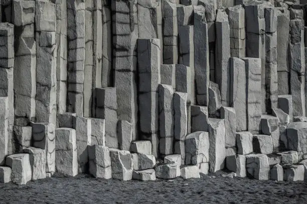 Photo of Vertical hexagonal basalt columns of Reynisfjall, Reynisfjara black beach, Iceland
