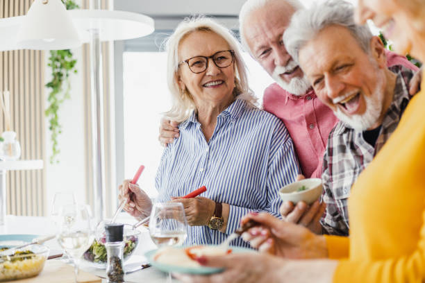 istock Senior preparing food and enjoying lunch 1407185871