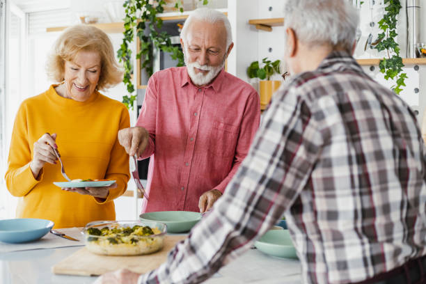 istock Senior preparing food and enjoying lunch 1407185922