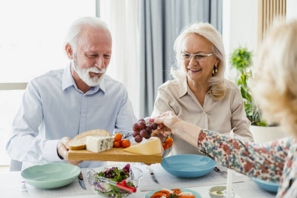 istock Seniors eating and socializing at the table 1407185971