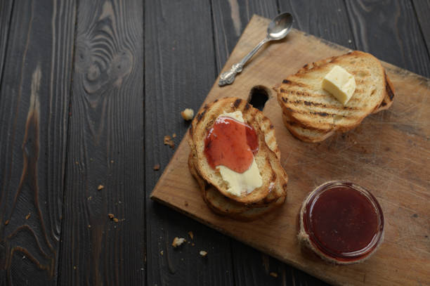 istock Toast bread with homemade strawberry jam and on rustic table with butter for breakfast or brunch. 1407187222