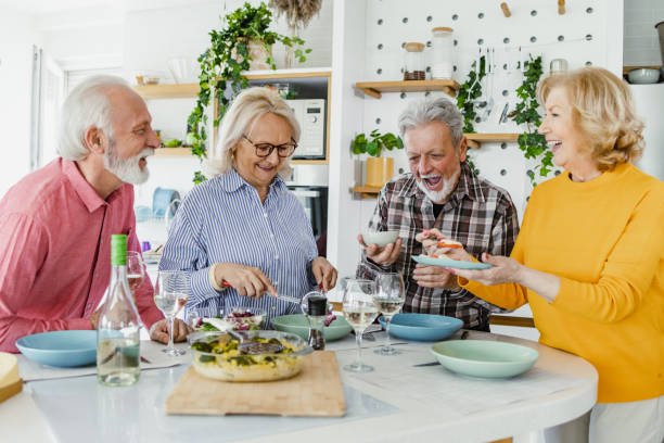 istock Cheerful seniors having lunch at home 1407187813