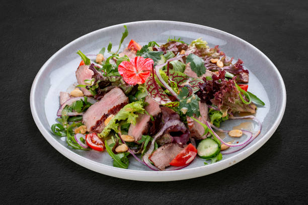 istock Josper-oven veal salad with sauce. On a dark background, isolated. 1407187861