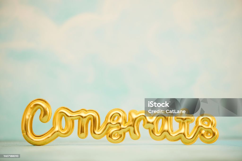 CONGRATULATIONS message in gold against blue sky with lots of space for copy Congratulating Stock Photo