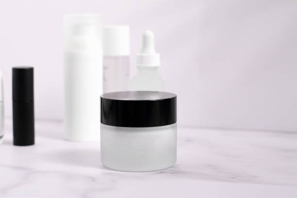 istock White and black glass jar for cosmetic cream on marble table 1407188190