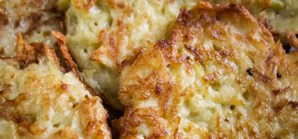 istock Freshly fried crispy golden potato pancake. From a close distance 1407190392