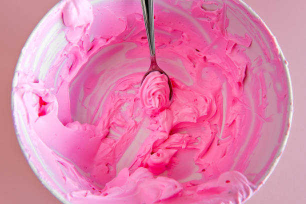 istock bowl with pink whipped cream scraping, pink chantilly. 1407191673