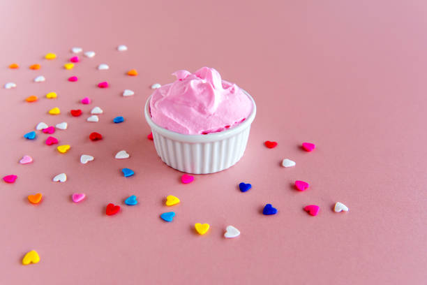 istock confectionery, whipping cream on pink background. 1407191849