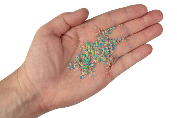 istock Micro plastic on a man's hand, top photo. Dots of colored plastic on the hand. 1407193602