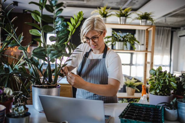 istock Young woman watching online tutorial about plant nursery 1407197222